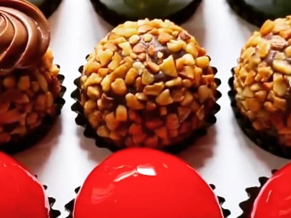 Rows of glazed bonbons and nut-rolled brigadeiros