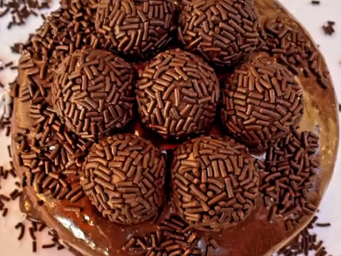 Brigadeiro cake topped with sprinkle-rolled brigadeiros